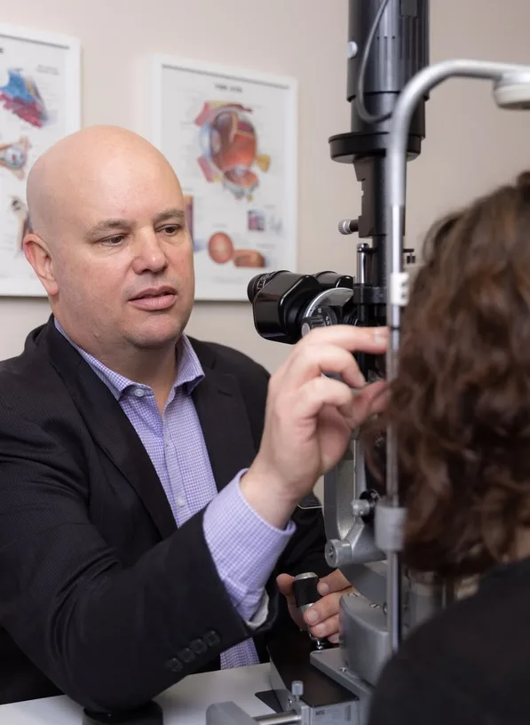 A/Prof Adrian Hunt examining a patient at the slit lamp